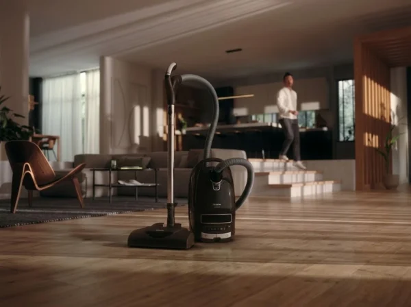 Miele Complete C3 Canister Vacuum Cleaner in modern living room - Appliances Nest