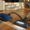 Miele Complete C3 Petrol Blue cleaning a wooden floor with LED
